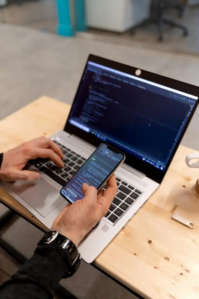 A programmer coding at lap top at coworking space