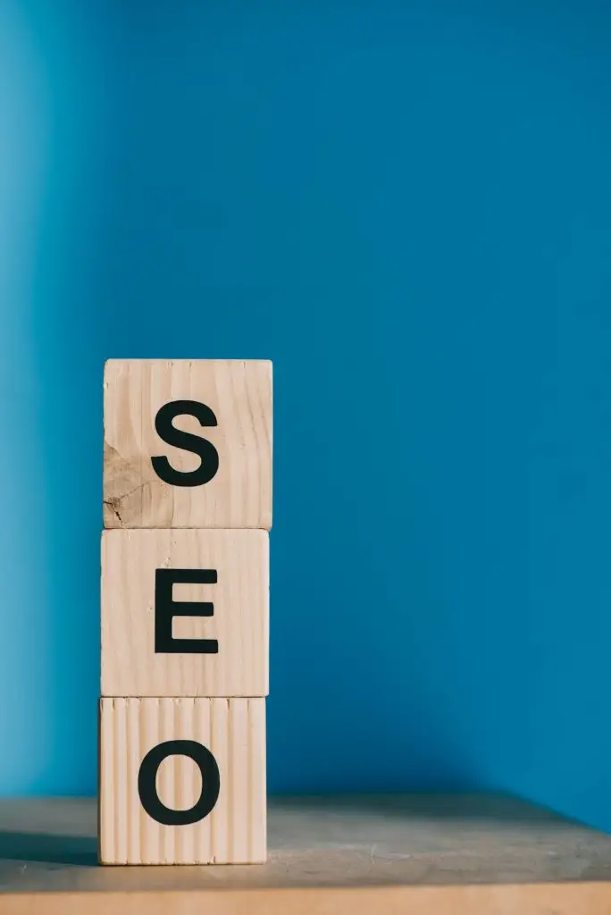 SEO word made from wooden cubes on blue background